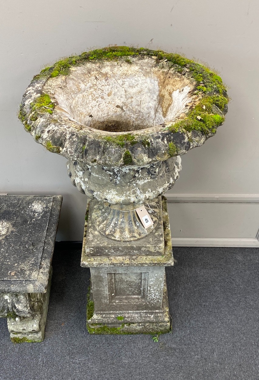 A reconstituted stone campana garden urn on square plinth, diameter 51cm, height 101cm